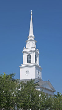 An old white church and steeple in downtown Sarasota, FL.