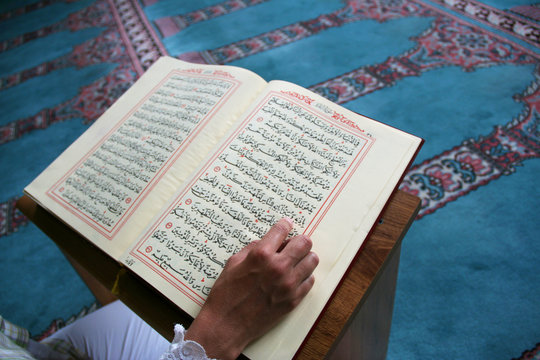 young woman reading the Koran