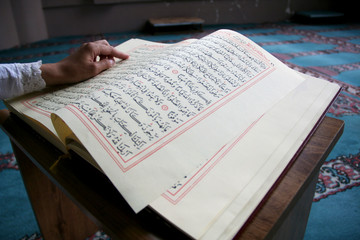young woman reading the Koran