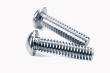 Two metal screws against white background