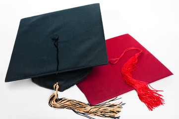 Black and red graduation caps with tassels.