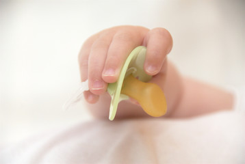 Babyhand with pacifier