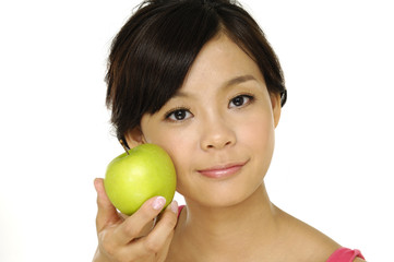 Pretty asian woman with green apple isolated