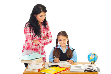 Teacher with schoolgirl in classroom