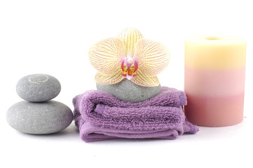 relaxing spa with candles, orchids ,towels and stones