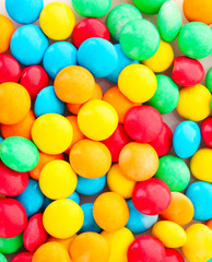 Fototapeta na wymiar background of multicolored candy coated chocolate sweets