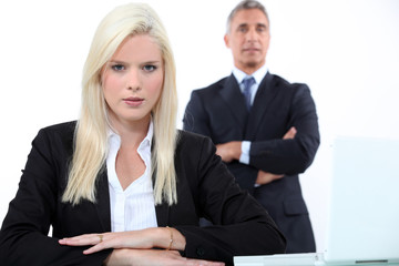 Young businesswoman with older male colleague