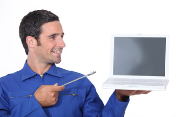 Man with a spanner and laptop computer