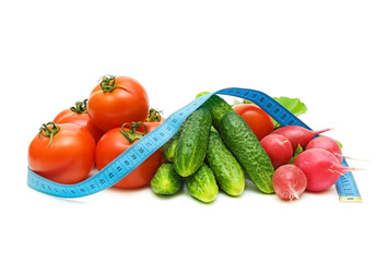 still life of fresh vegetables and a measuring tape