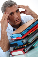 Man with stacks of paperwork