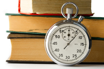 Stopwatch and books on the white background