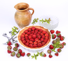 Strawberry Tart, plates, a pot, strawberries and mint twigs