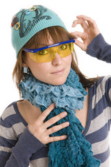 girl in a turquoise hat and scarf and yellow glasses