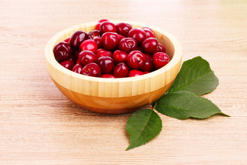 cherry in bowl on wooden background