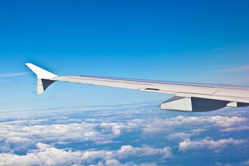 Wing of aircraft in the blue sky