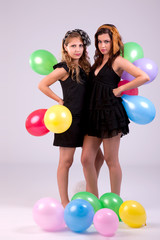 Fototapeta na wymiar two beautiful women, with colored ballons