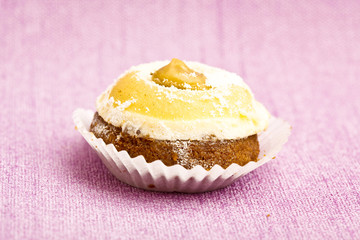 Beautiful little cake on colorful wallpaper background