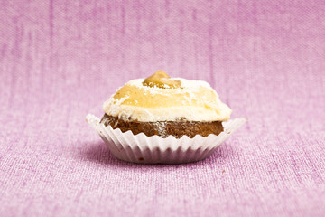 Beautiful little cake on colorful wallpaper background