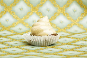 Beautiful little cake on colorful wallpaper background