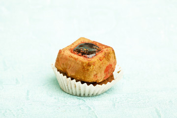 Beautiful little cake on colorful wallpaper background