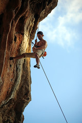 Rock climber against blue sky