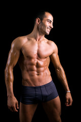 Fototapeta na wymiar Sexy muscular man against black background