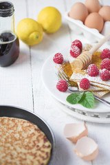 Freshly prepared crepes with raspberries