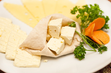 Several types of cheese served on a plate