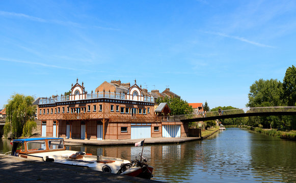 Boat house in the center of Amiens, France. On the shore of the