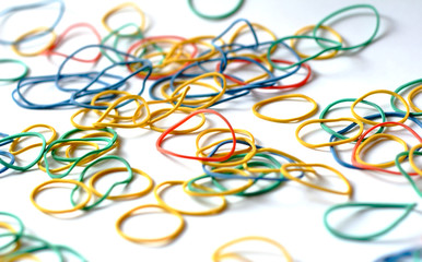 Colorful rubber bands on white background