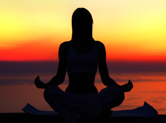 Yoga woman over sunset