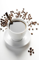 cup of coffee with coffee grains isolated on white