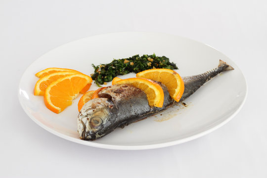 A plate of Torpedo Scad fish with salsa verde