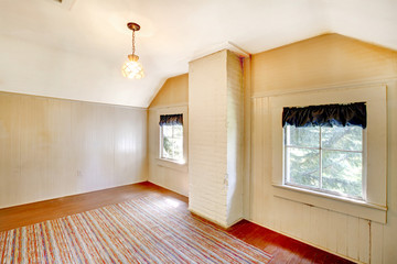 Very old bedroom empty with white walls.