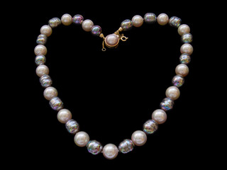 heart of pearl necklace over black background