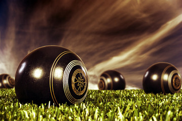 Close up of bowling balls on a bowling field at sunset