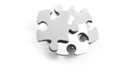 Stainless steel puzzle pieces on white background