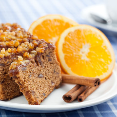 Gingerbread with orange and cup of coffee or tea.