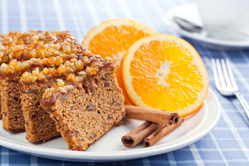 Gingerbread with orange and cup of coffee or tea.