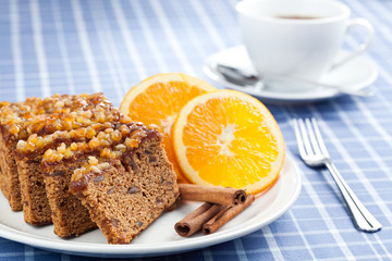Gingerbread with orange and cup of coffee or tea.