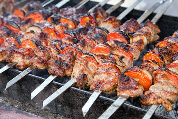 Juicy slices of meat with sauce prepare on fire (shish kebab)