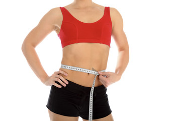 Sporty woman with a measuring tape round the waist