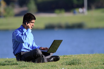 businessman with laptop and cell phone