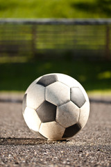 Fototapeta na wymiar Soccer ball on asphalt