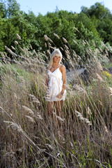 Fototapeta na wymiar girl are standing in dry grass