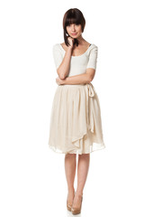 Full-body portrait of young elegant female in summer dress