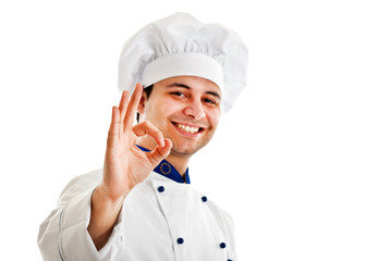 Smiling chef isolated on white showing ok hand sign