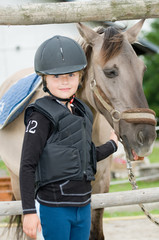 Little jockey and horse portrait