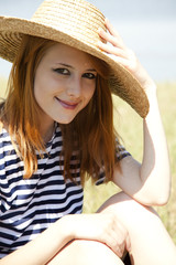 Beautiful redhead girl at countryside nead lake.