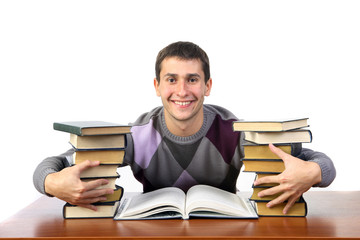 the guy is sitting among the books